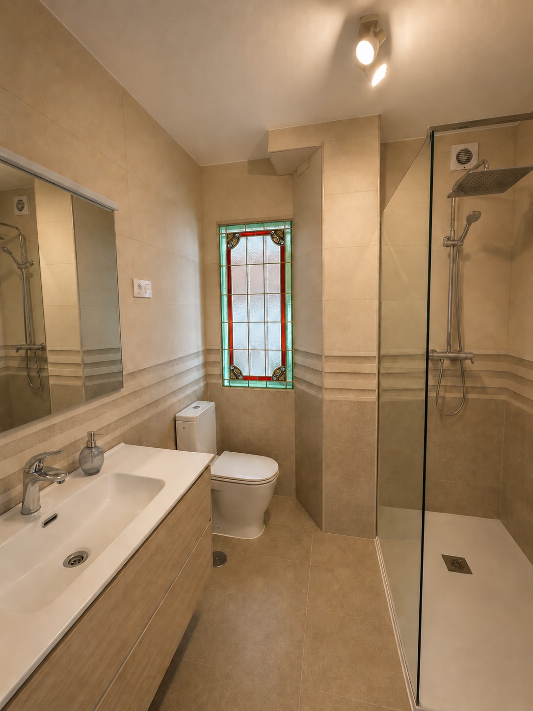 A bathroom with a stained-glass window and a walk-in rain shower.
