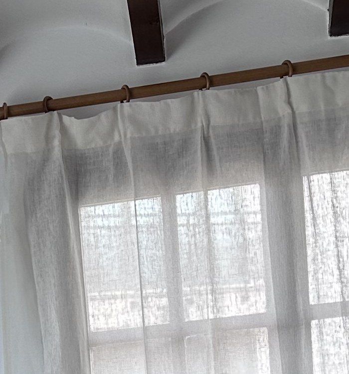 Sunlight through sheer linen curtains.